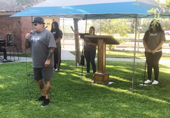 Living Word Church Pastor Albert Toralez delivers words Saturday evening, in the park across from his church, protesting COVID-19 guidelines aimed at indoor church services. 